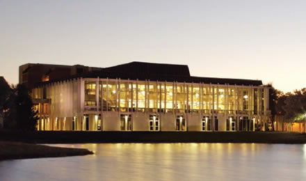 Rush Library building at night.