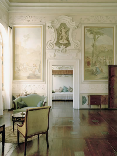 Villa Cornaro interior wall sculpture above doorway between two paintings brighter lighting. 